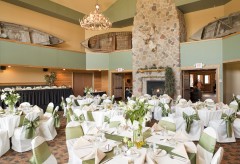 Reception setup with many round tables and one long rectangular table for the bridal party